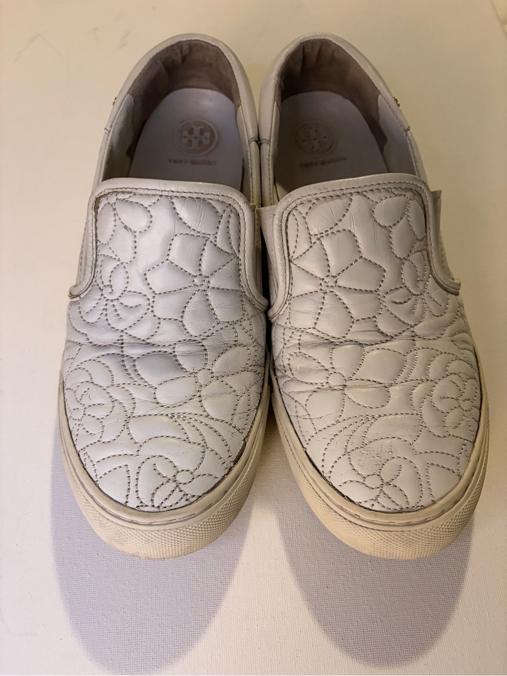 Women's Tory Burch off-white Sela floral quilted leather slip on sneakers/shoes.